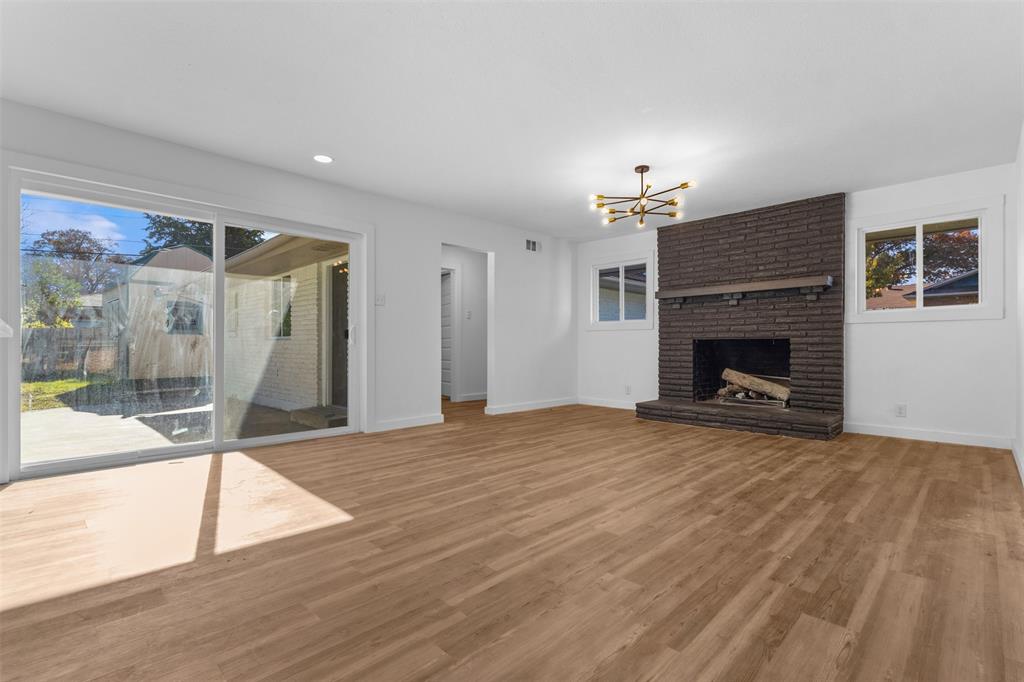 924 Whitestone Lane Dallas, TX 75232 - Photo 8 of 32 a view of a livingroom with a fireplace and window