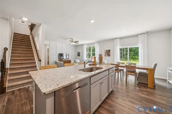 a kitchen with sink and view of living room
