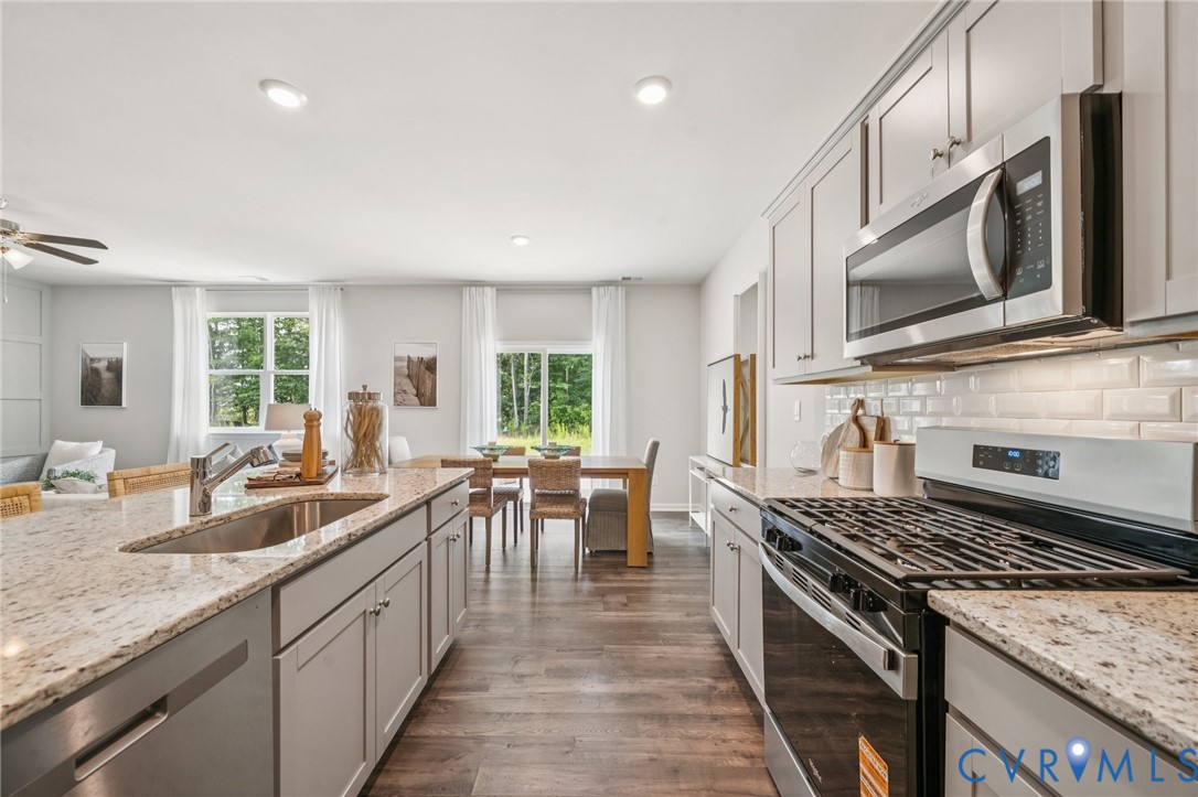 Lot 111 Rte 1 Richmond, VA 23237 - Photo 12 of 45 a kitchen with stove a sink and chairs