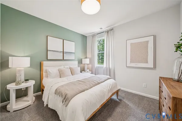 a bedroom with a bed and a lamp