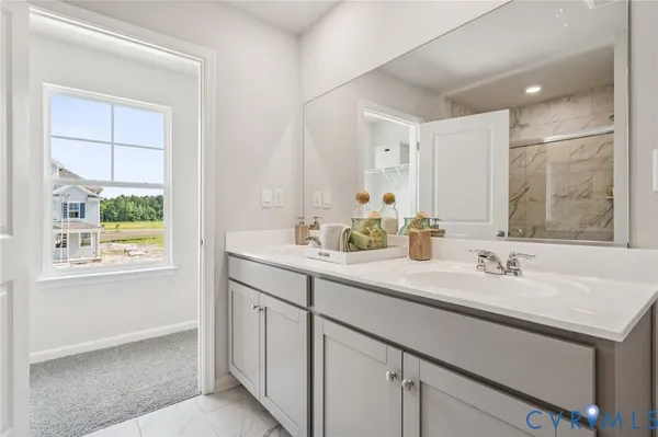 a bathroom with a sink double vanity and a mirror