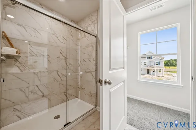 a bathroom with a bathtub and shower