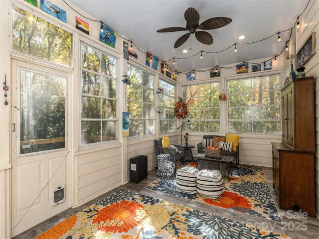 a living room with fireplace furniture and a large window