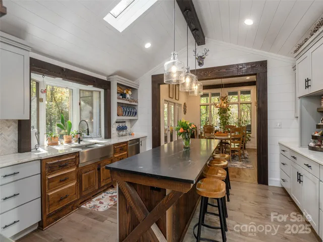 a kitchen with a table chairs stove and cabinets