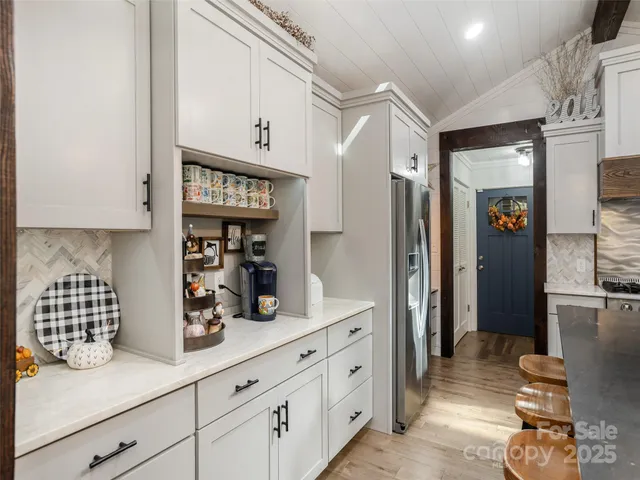 a kitchen with stainless steel appliances white cabinets and a refrigerator