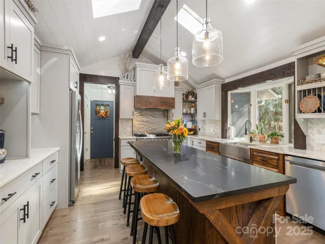 a kitchen with stainless steel appliances granite countertop counter space dining table and chairs