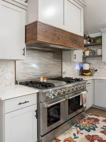 a kitchen with stainless steel appliances granite countertop a stove and a sink