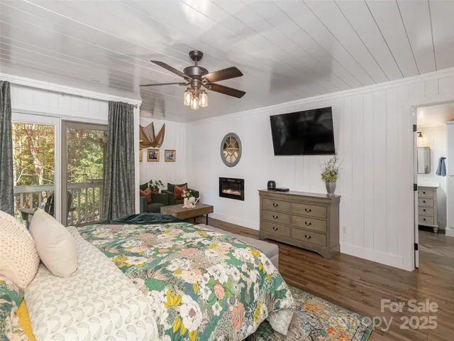 a bed room with a bed a television and dresser