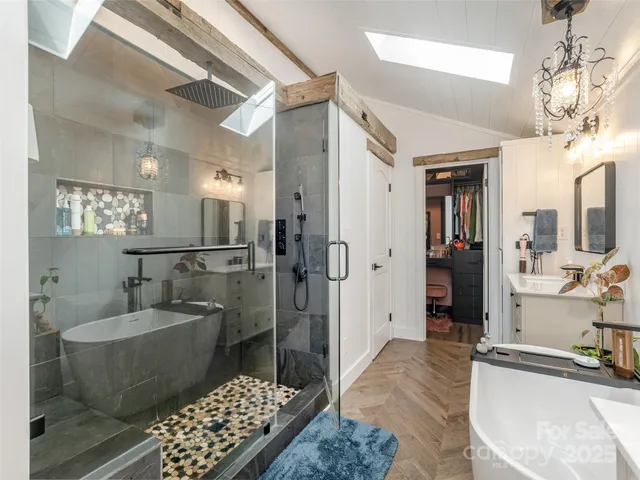 a spacious bathroom with a double vanity sink a mirror and a shower