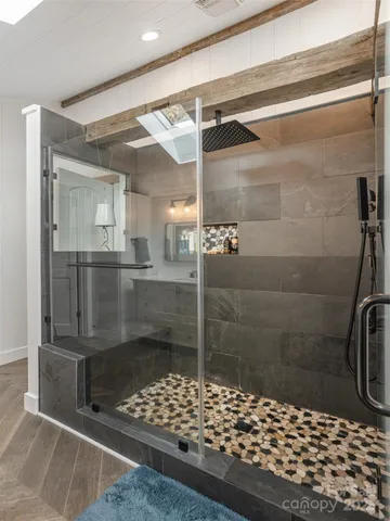 a bathroom with a glass shower door