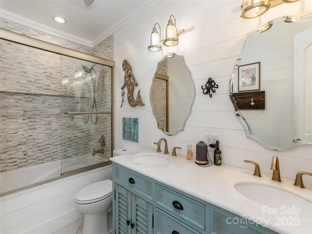 a bathroom with a double vanity sink toilet and shower