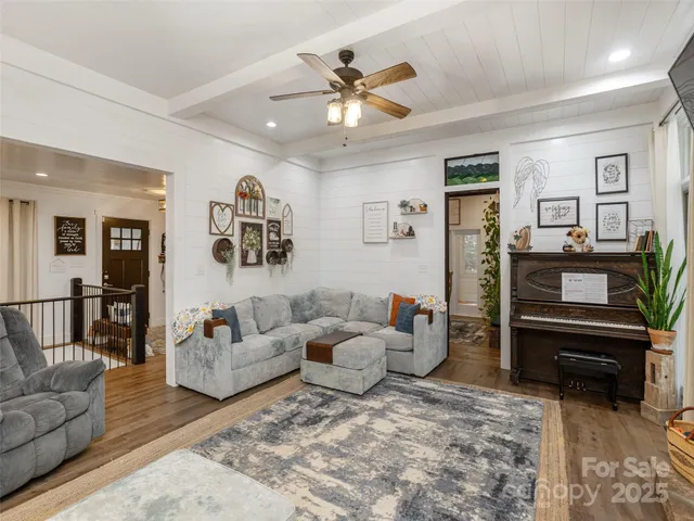 a living room with furniture and wooden floor
