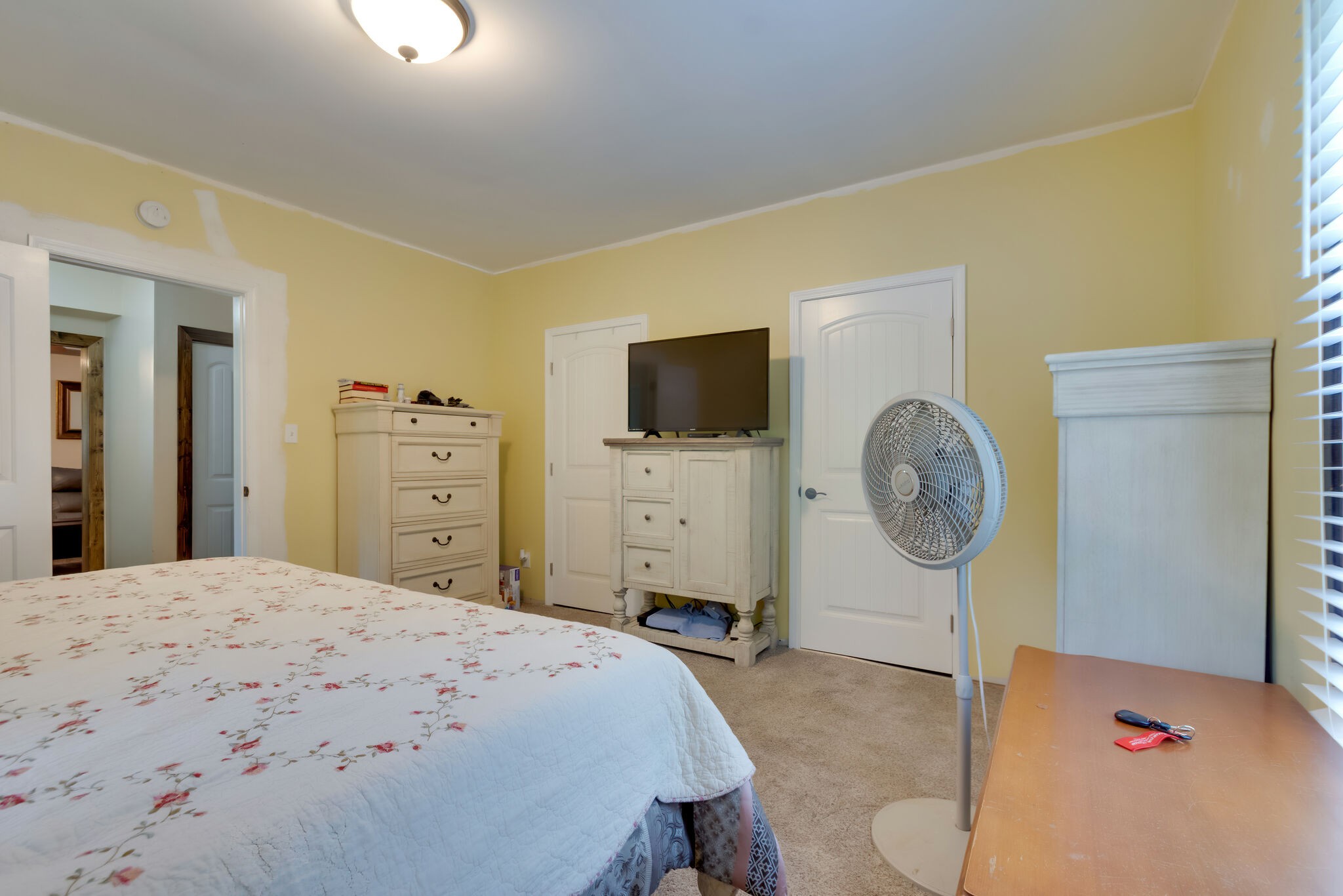 585 Shorts Road Pulaski, TN 38478 - Photo 12 of 32 a bedroom with a bed a mirror on dresser and a chandelier