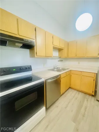a kitchen with a sink cabinets and a microwave