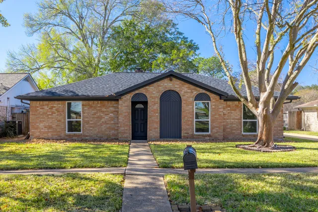 a living room with furniture a ceiling fan and a wooden floor