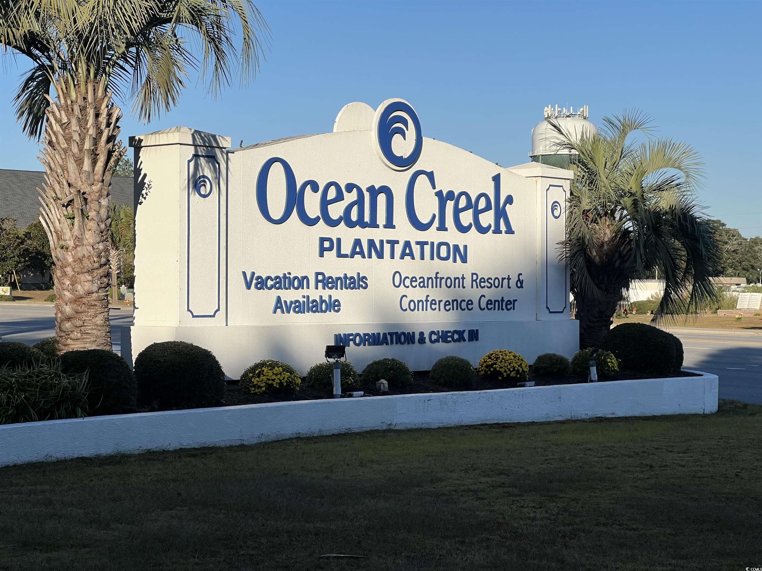 100 Ocean Creek Drive, Unit M3 Myrtle Beach, SC 29572 - Photo 32 of 32 Community sign with a yard