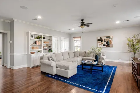 a living room with furniture and wooden floor