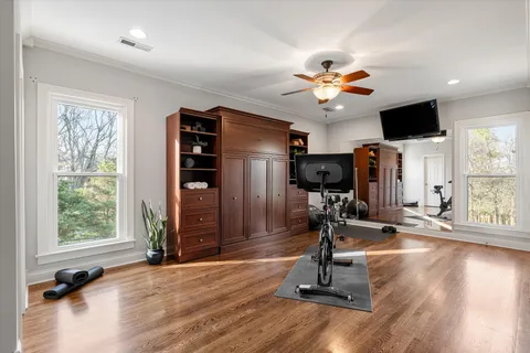 a view of a room with gym equipment and a large window