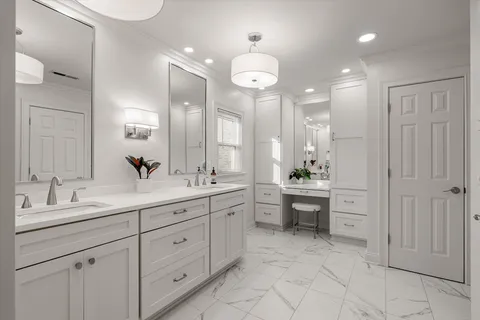 a large bathroom with a double vanity sink a mirror and a bathtub