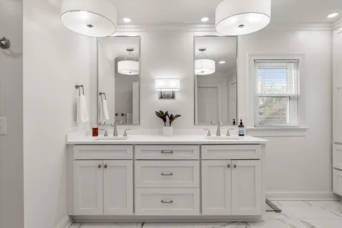 a bathroom with a sink vanity and mirror