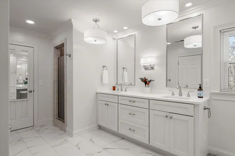 a bathroom with a double vanity sink mirror and double