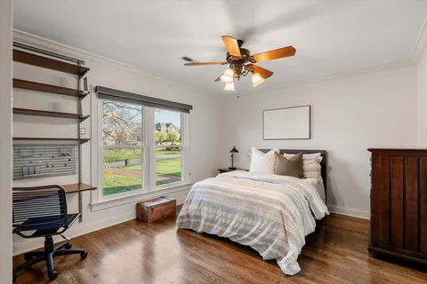 a bedroom with a bed and a large window