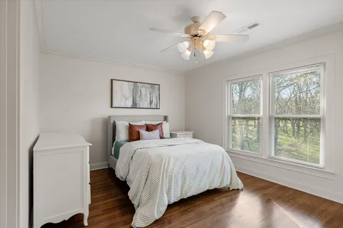 a bedroom with a large bed and a chandelier