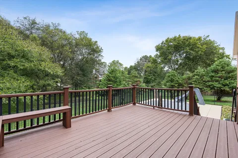 a balcony with wooden floor and fence