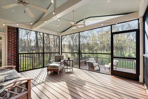 a living room with furniture and floor to ceiling windows