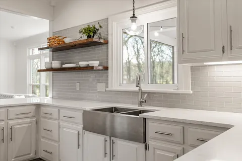 a kitchen with a sink cabinets and window