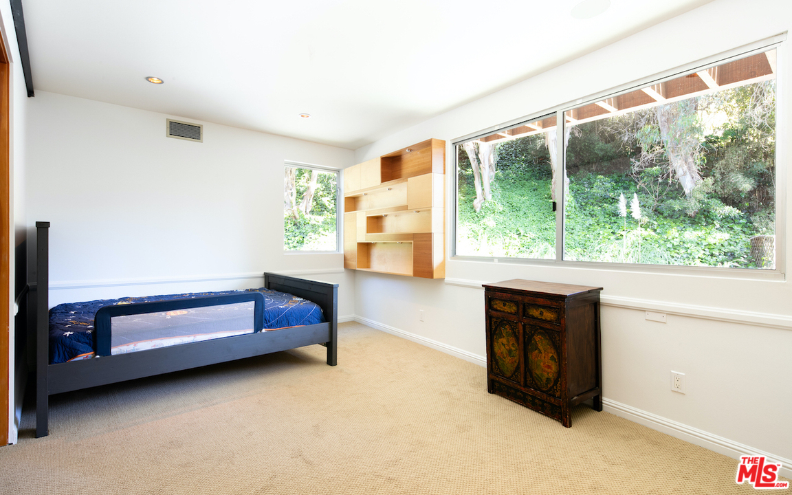 562 Stassi Lane Santa Monica, CA 90402 - Photo 17 of 33 a living room with furniture and a large window
