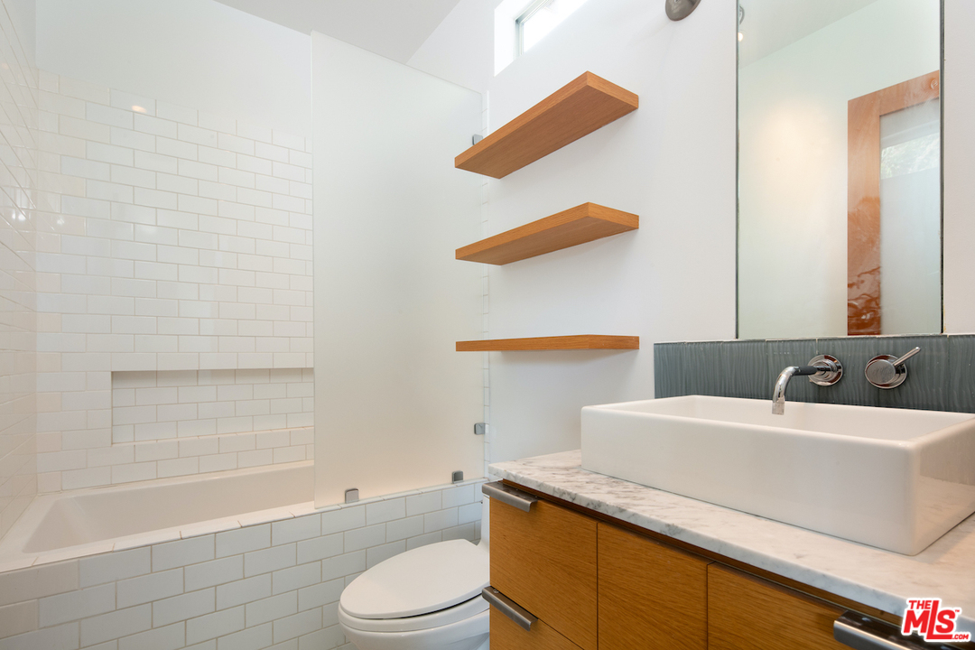 562 Stassi Lane Santa Monica, CA 90402 - Photo 20 of 33 a bathroom with a sink a toilet and shower