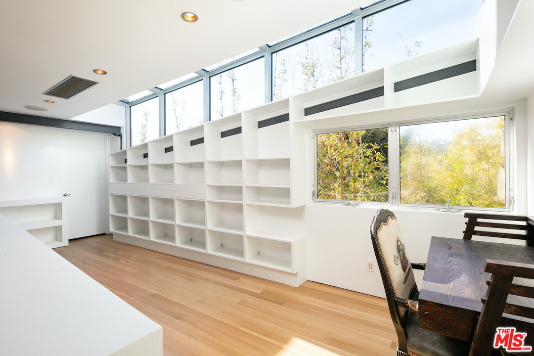 562 Stassi Lane Santa Monica, CA 90402 - Photo 21 of 33 a view of an empty room with wooden floor and windows