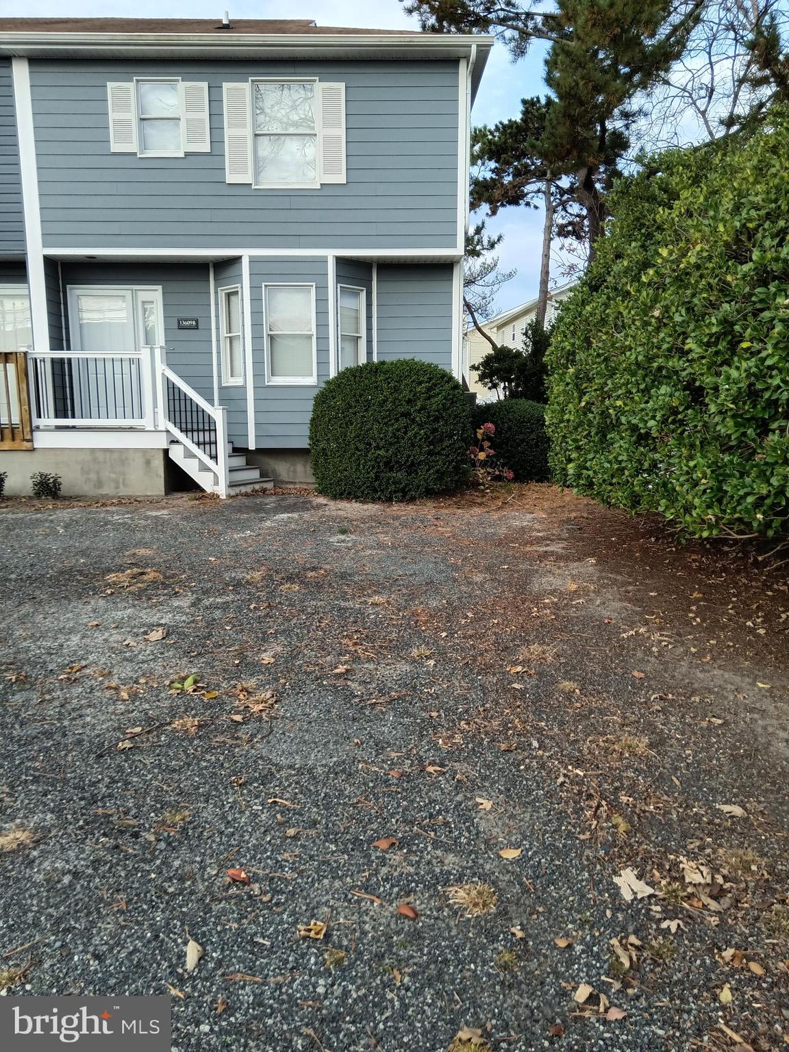 13609 Derrickson Avenue, Unit B Ocean City, MD 21842 - Photo 1 of 47 a front view of a house with a yard