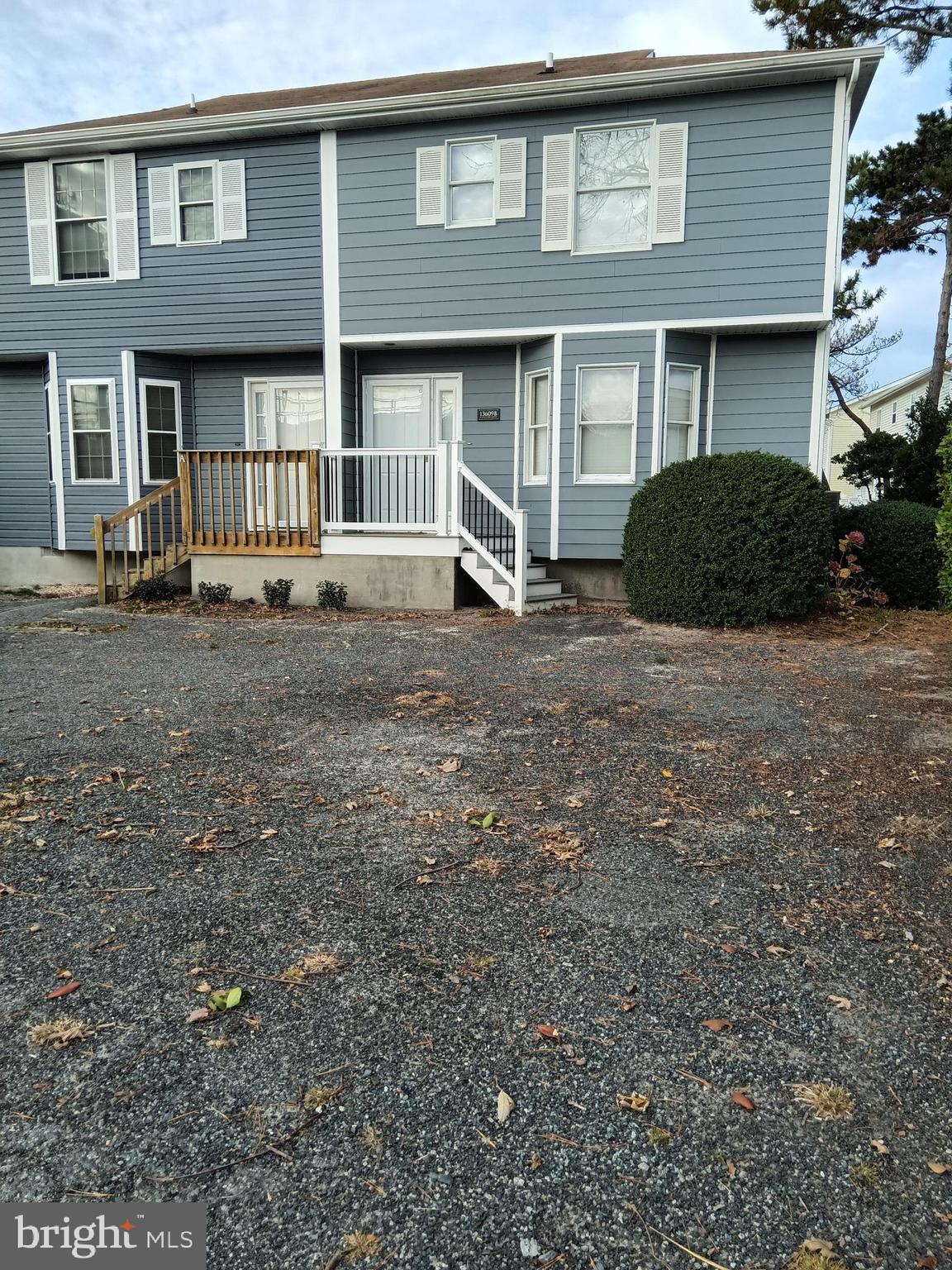 13609 Derrickson Avenue, Unit B Ocean City, MD 21842 - Photo 2 of 47 a front view of a house with a yard