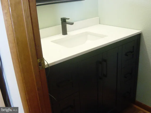 a white toilet sitting next to a bathroom sink