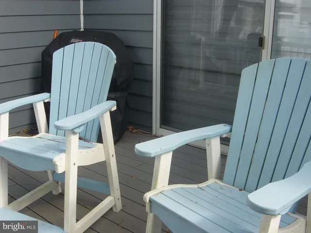 a view of a house with a backyard and a bench