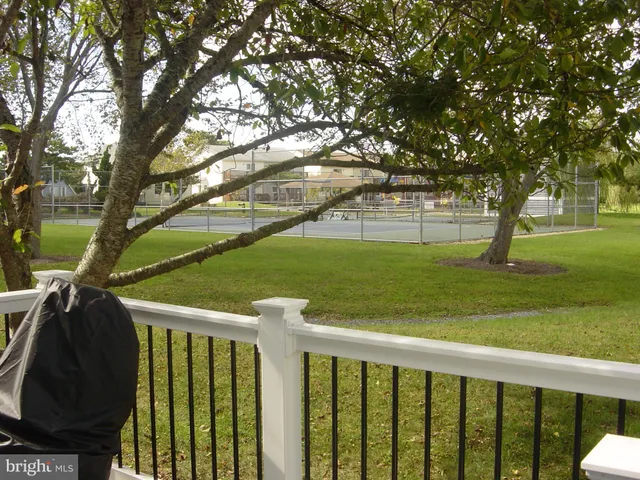a view of house with backyard and deck