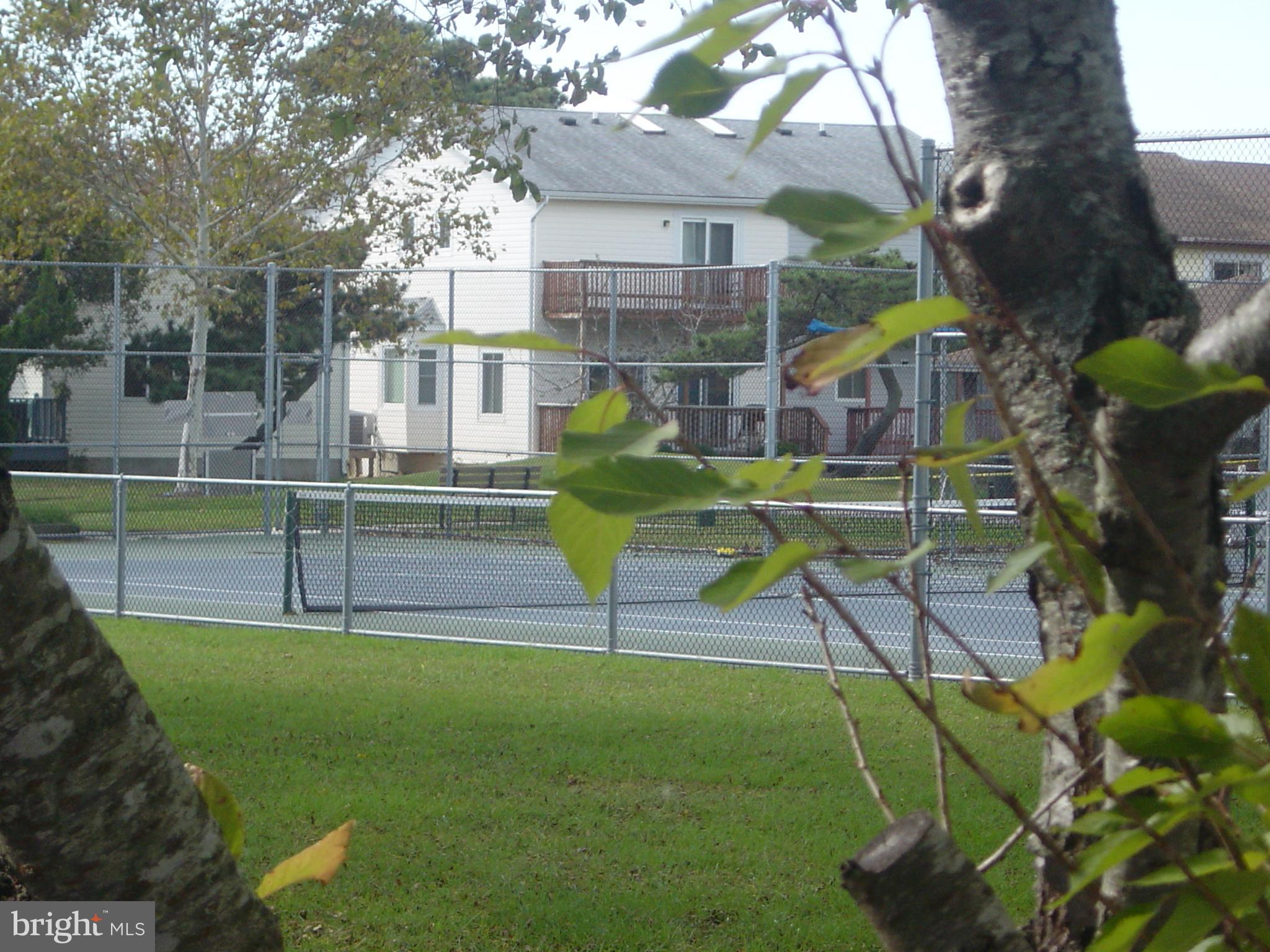 13609 Derrickson Avenue, Unit B Ocean City, MD 21842 - Photo 38 of 47 a view of a house with a backyard and a bench