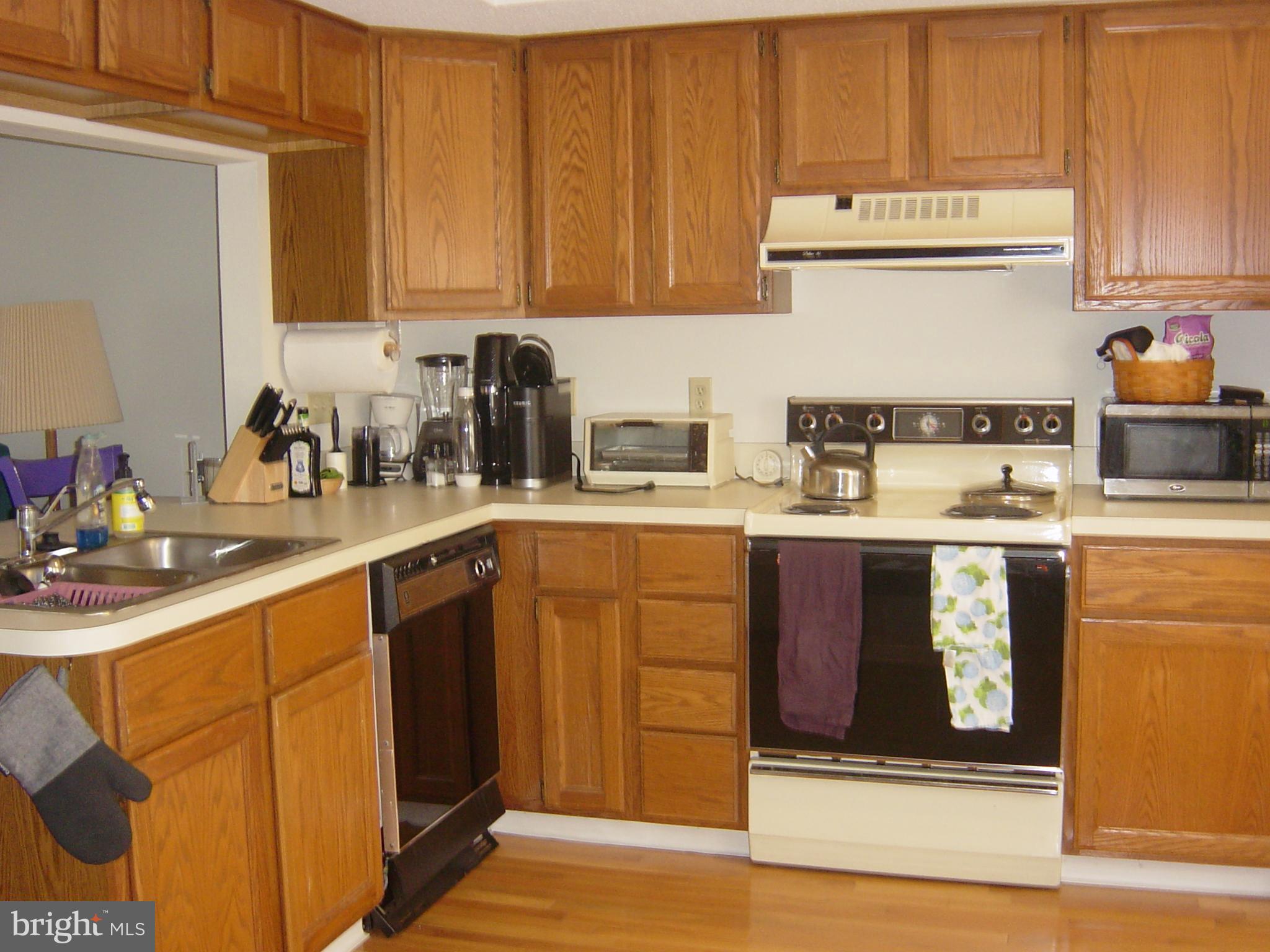 13609 Derrickson Avenue, Unit B Ocean City, MD 21842 - Photo 7 of 47 a kitchen with stainless steel appliances granite countertop a sink stove and cabinets