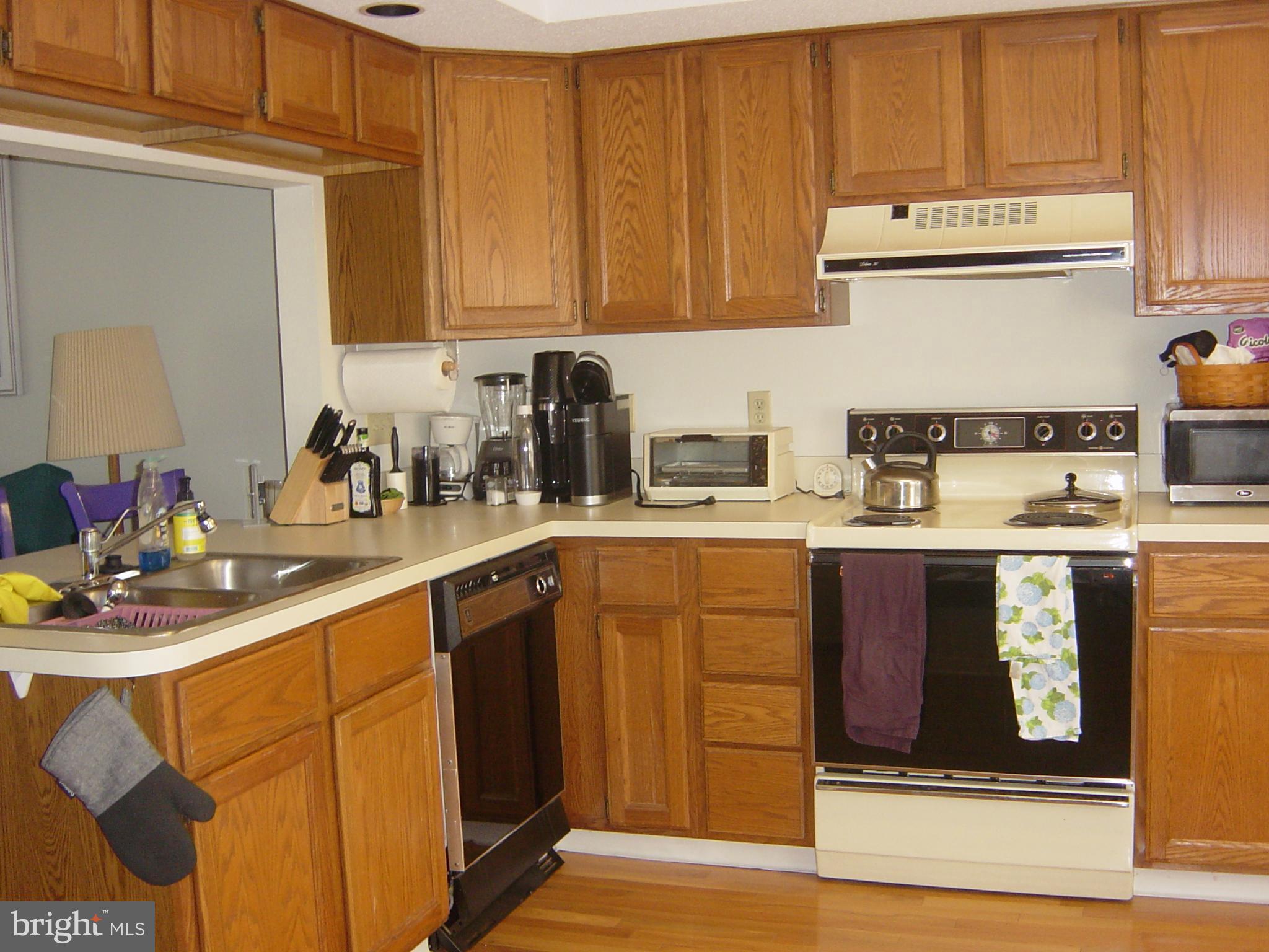 13609 Derrickson Avenue, Unit B Ocean City, MD 21842 - Photo 8 of 47 a kitchen with stainless steel appliances granite countertop a sink stove and cabinets