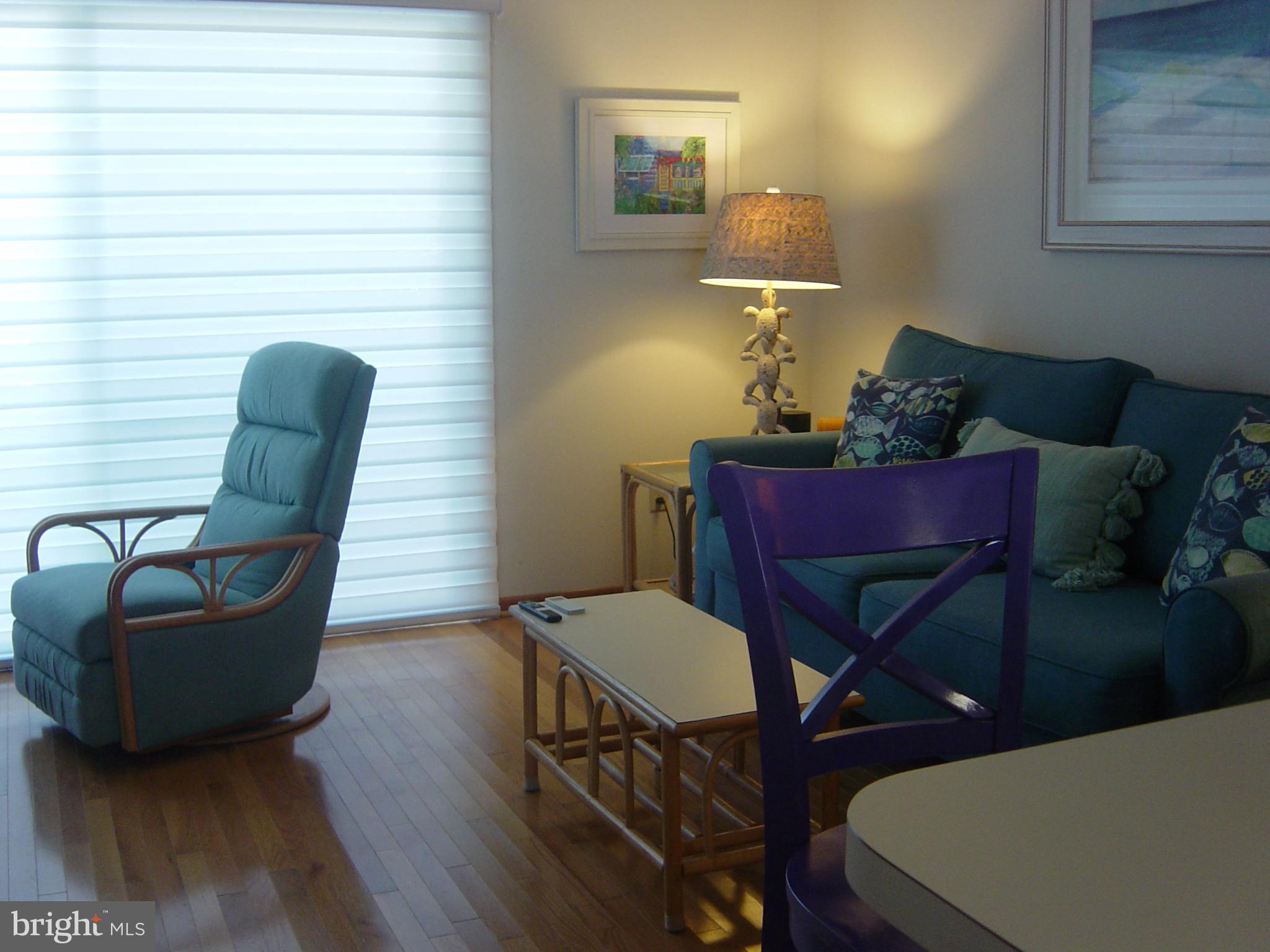 13609 Derrickson Avenue, Unit B Ocean City, MD 21842 - Photo 9 of 47 a living room with furniture a lamp and a potted plant