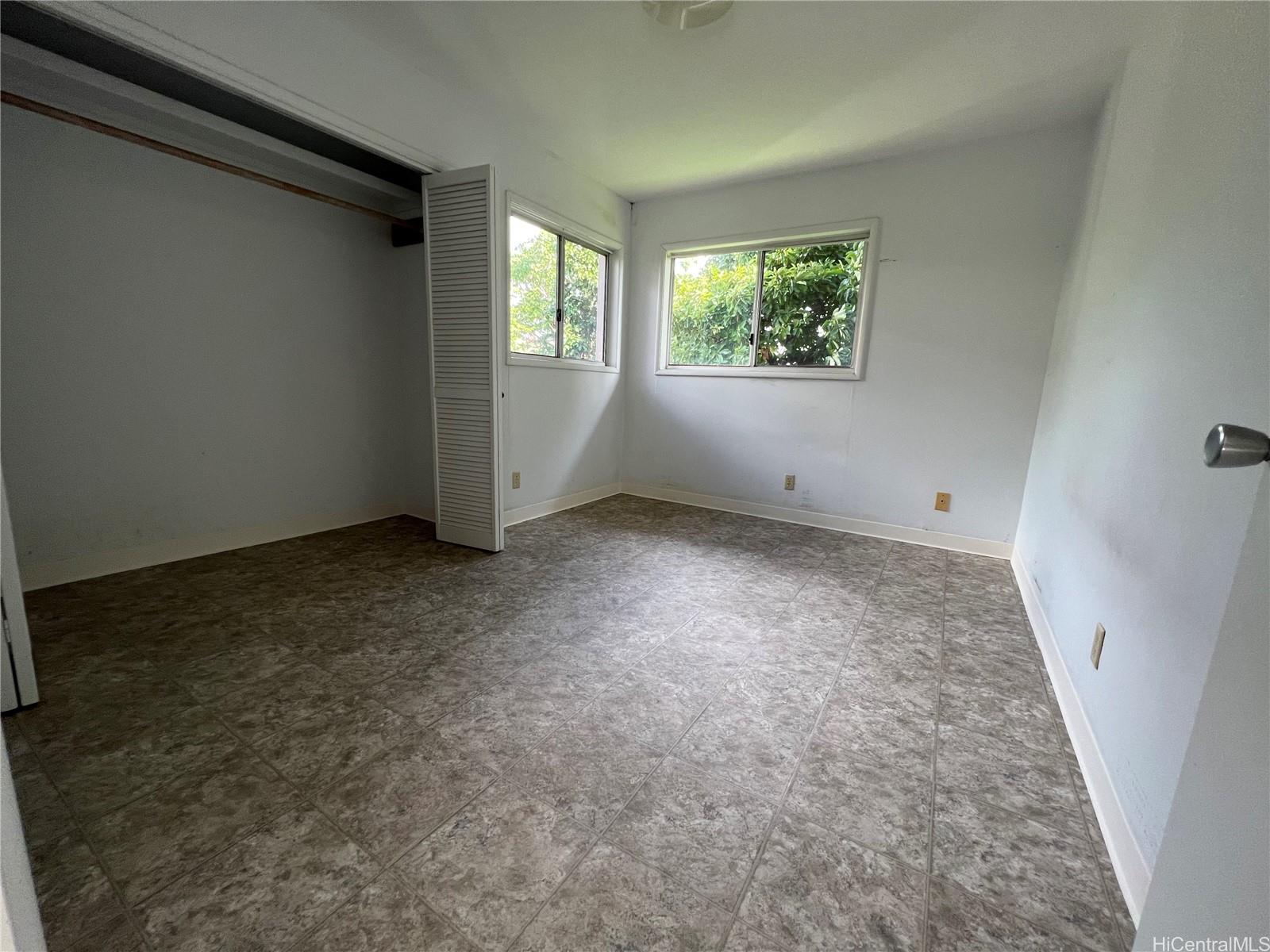 98-1305 Akaaka Street Aiea, HI 96701 - Photo 16 of 23 an empty room with windows