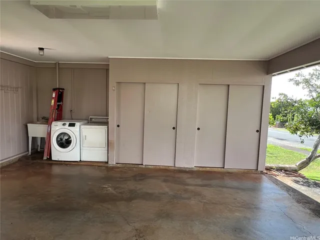 a view of a storage & utility room with a washer dryer