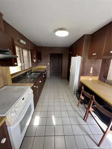 a kitchen with a sink cabinets and appliances