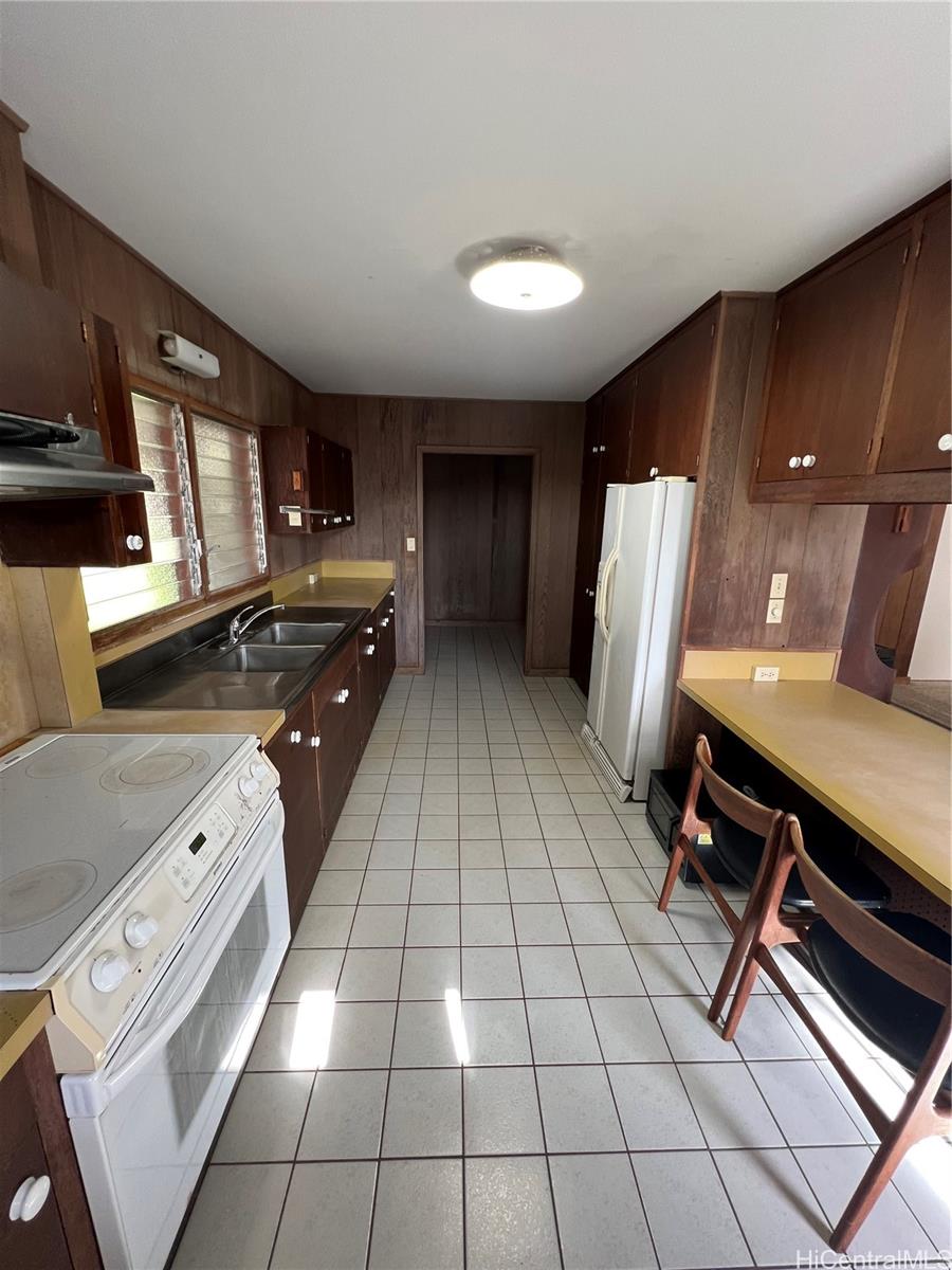 98-1305 Akaaka Street Aiea, HI 96701 - Photo 3 of 23 a kitchen with a sink cabinets and appliances