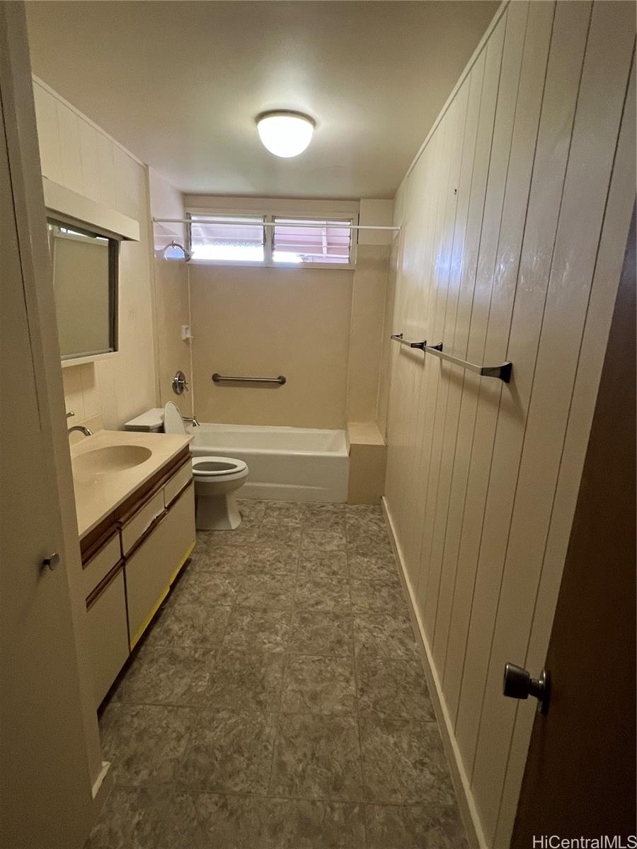 98-1305 Akaaka Street Aiea, HI 96701 - Photo 4 of 23 a bathroom with a tub a sink and a large mirror