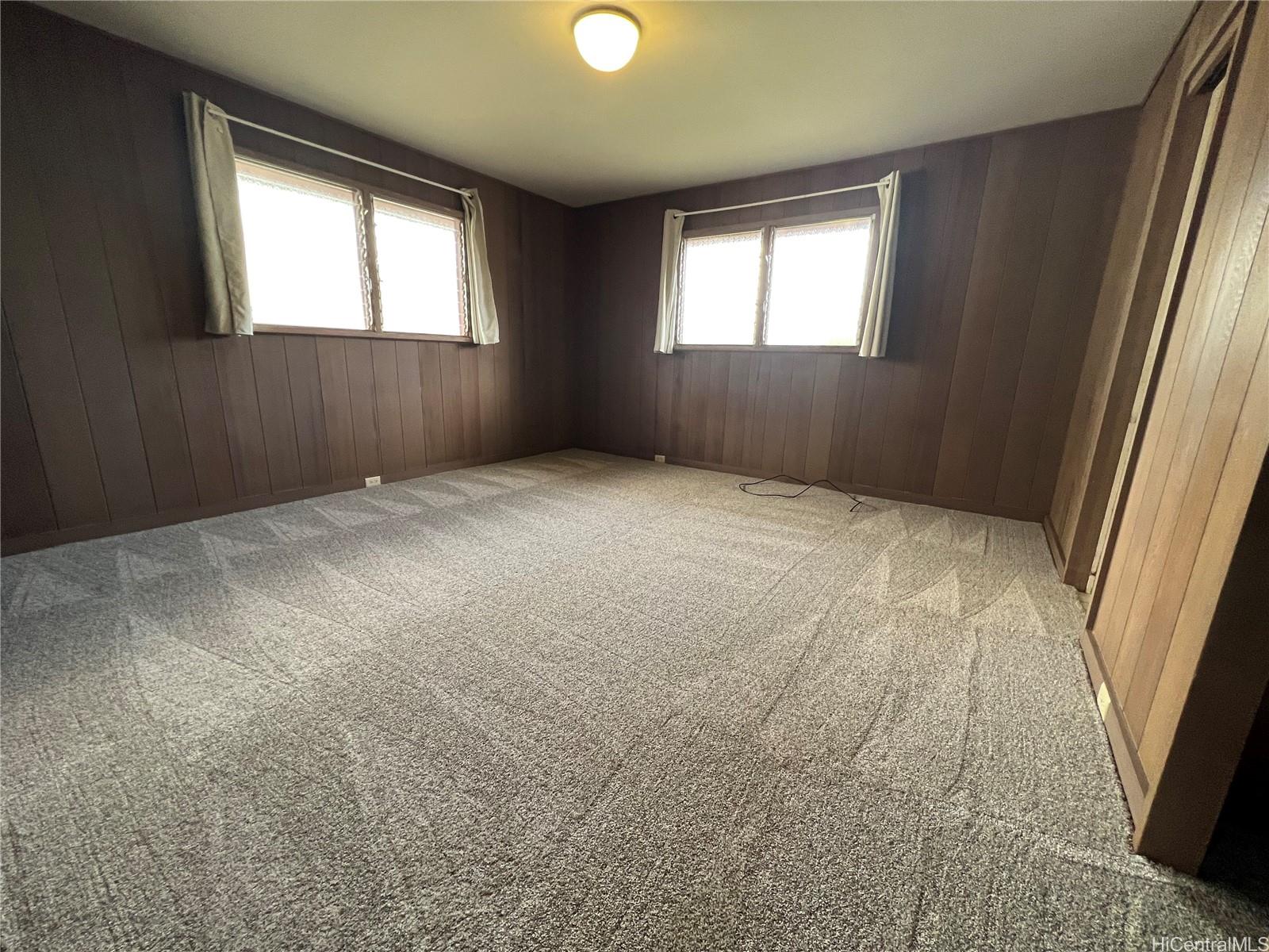 98-1305 Akaaka Street Aiea, HI 96701 - Photo 7 of 23 an empty room with windows