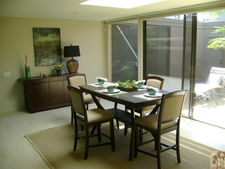 77950 Cherokee Road Indian Wells, CA 92210 - Photo 13 of 22 a dining room with furniture and wooden floor