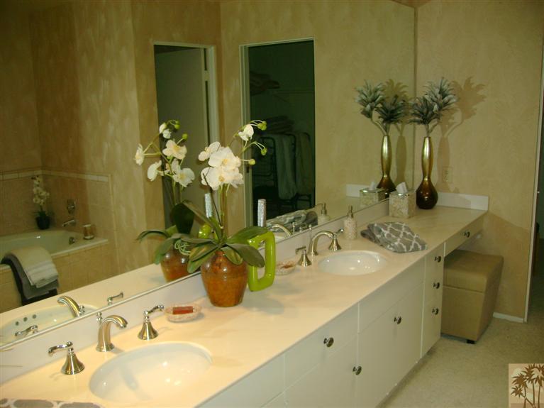 77950 Cherokee Road Indian Wells, CA 92210 - Photo 17 of 22 a bathroom with a granite countertop sink a large mirror and a shower